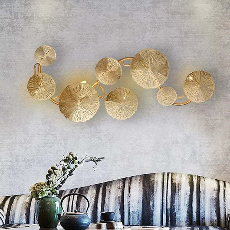 Gold Lotus Leaf Wall Lamp above sofa