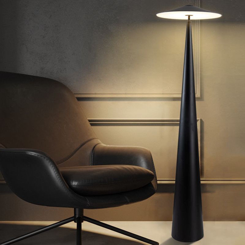 Modern black metal floor lamp and leather armchair