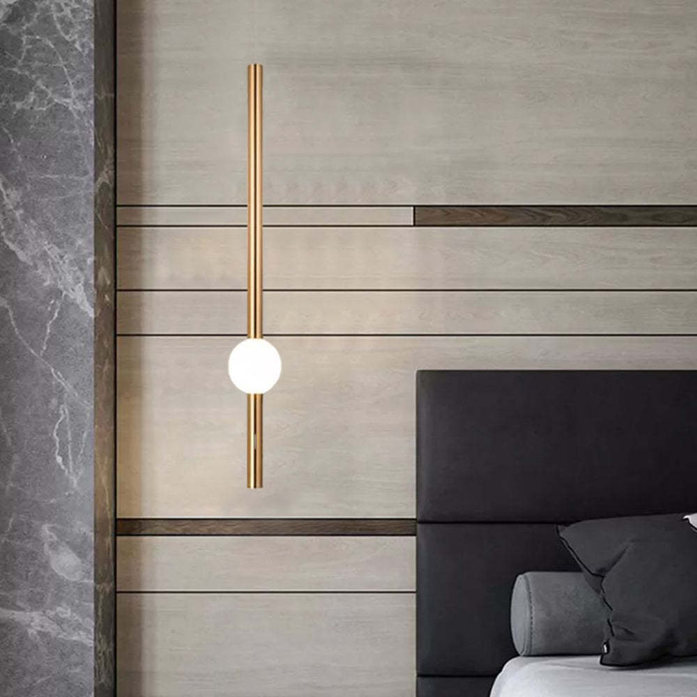 Modern gold pendant light in bedroom setting