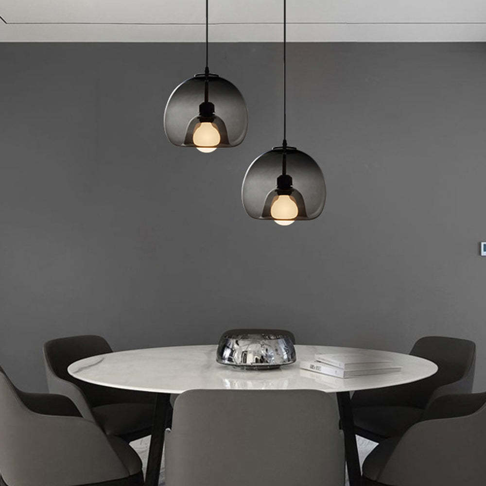 Dining room with smoky gray globe pendant lights.