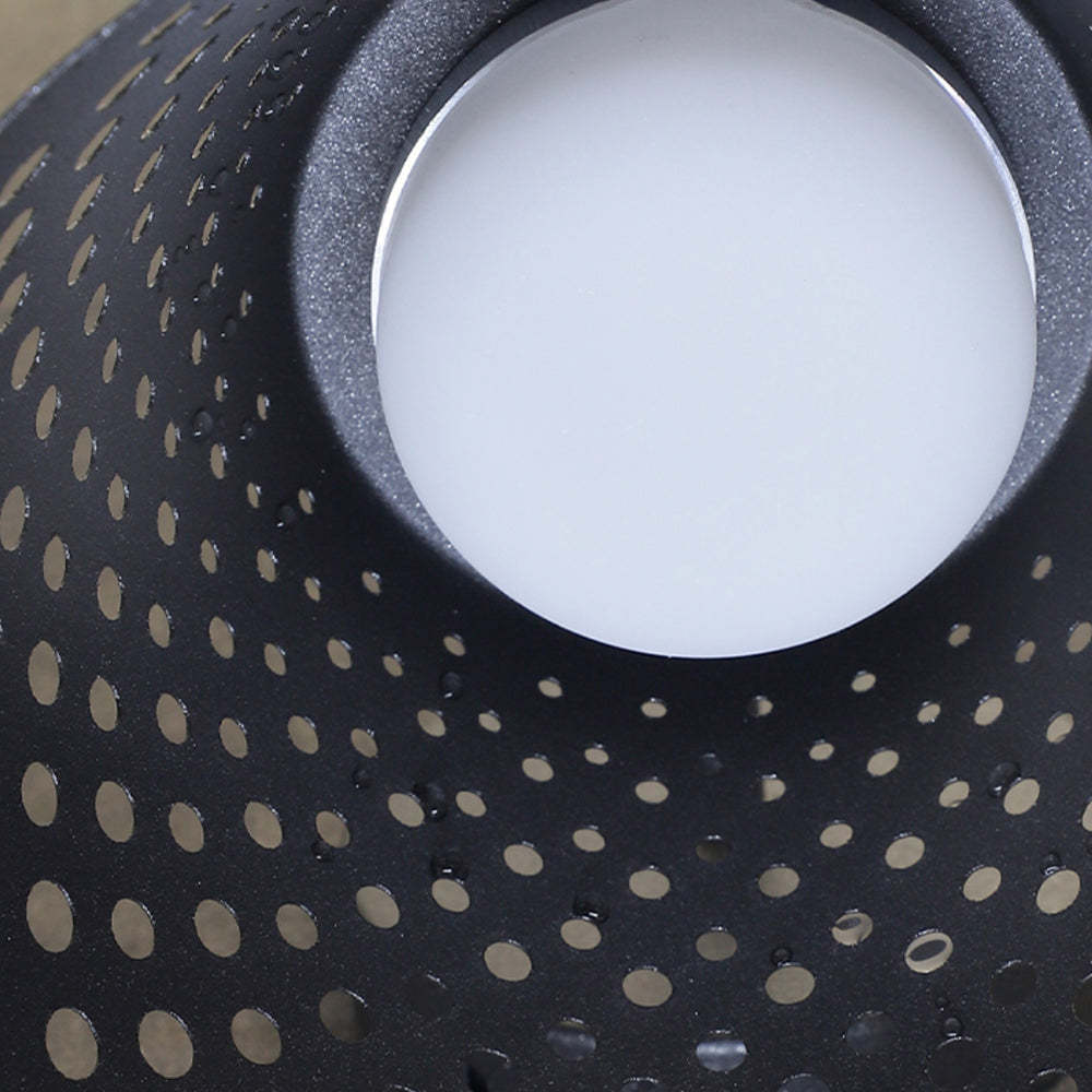 Carins metal outdoor wall lamp perforated shade close up.