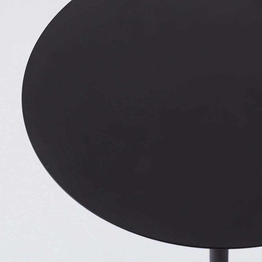 Close-up of Valentina floor lamp table, black metal surface.