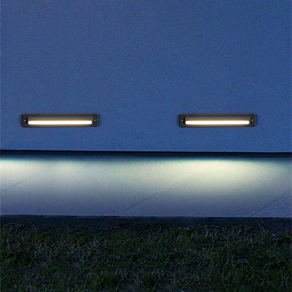 Rectangular outdoor step lights illuminating a blue wall and pathway