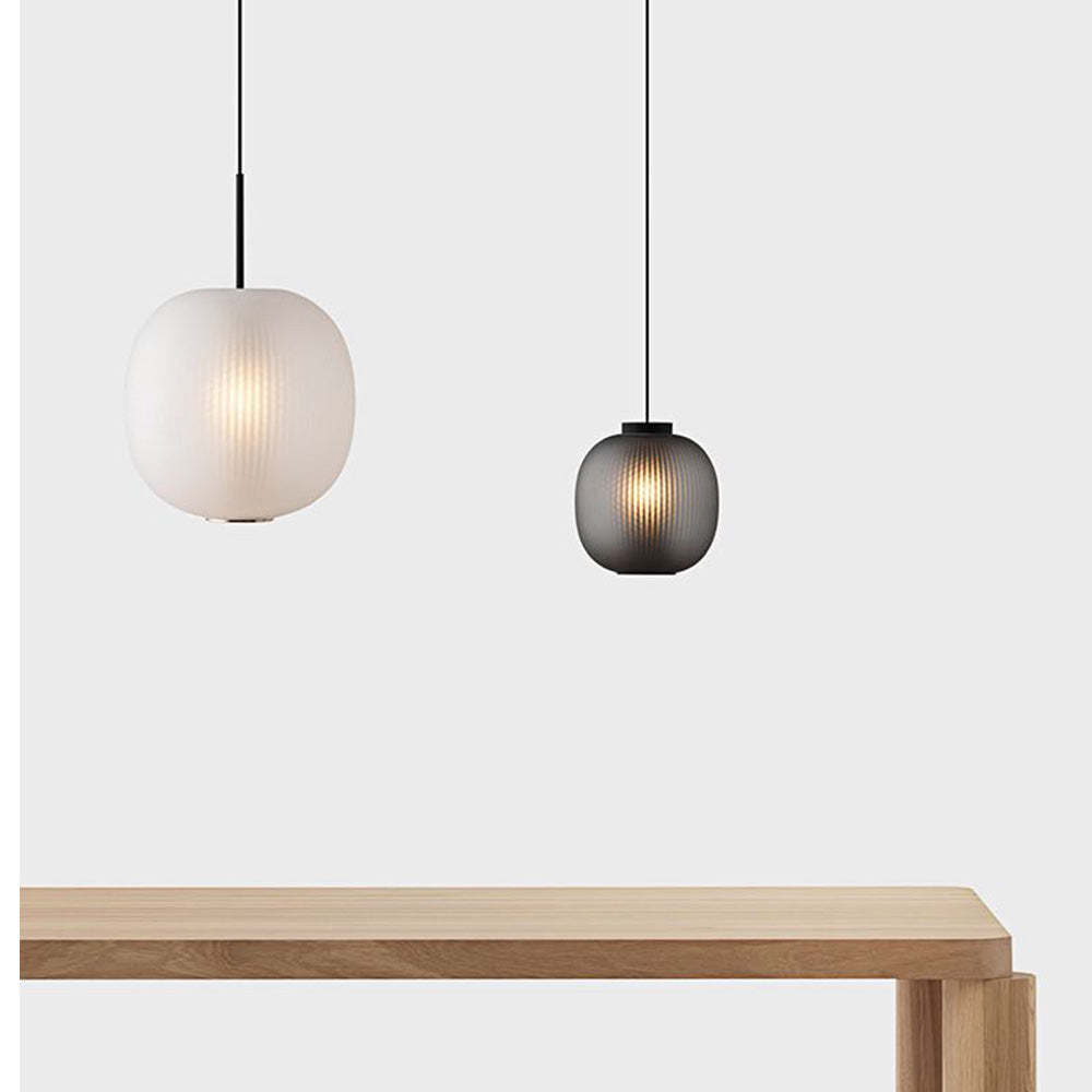 Hailie Frosted Glass Pendant Lights in white and black over table
