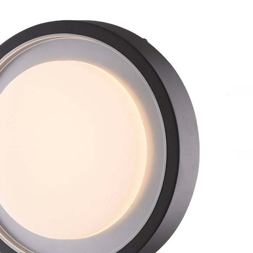 Orr Outdoor Wall Lamp close-up, disc shape with warm light