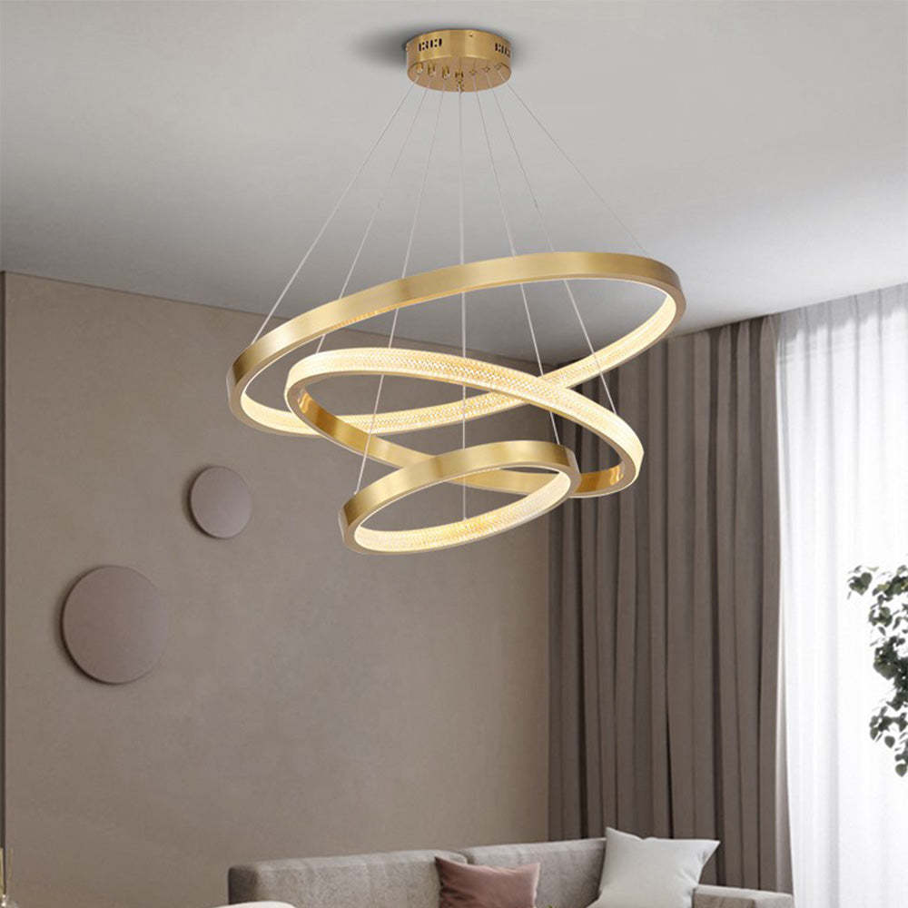 Gold Kirsten Modern Ring LED Pendant Light illuminating a living room.
