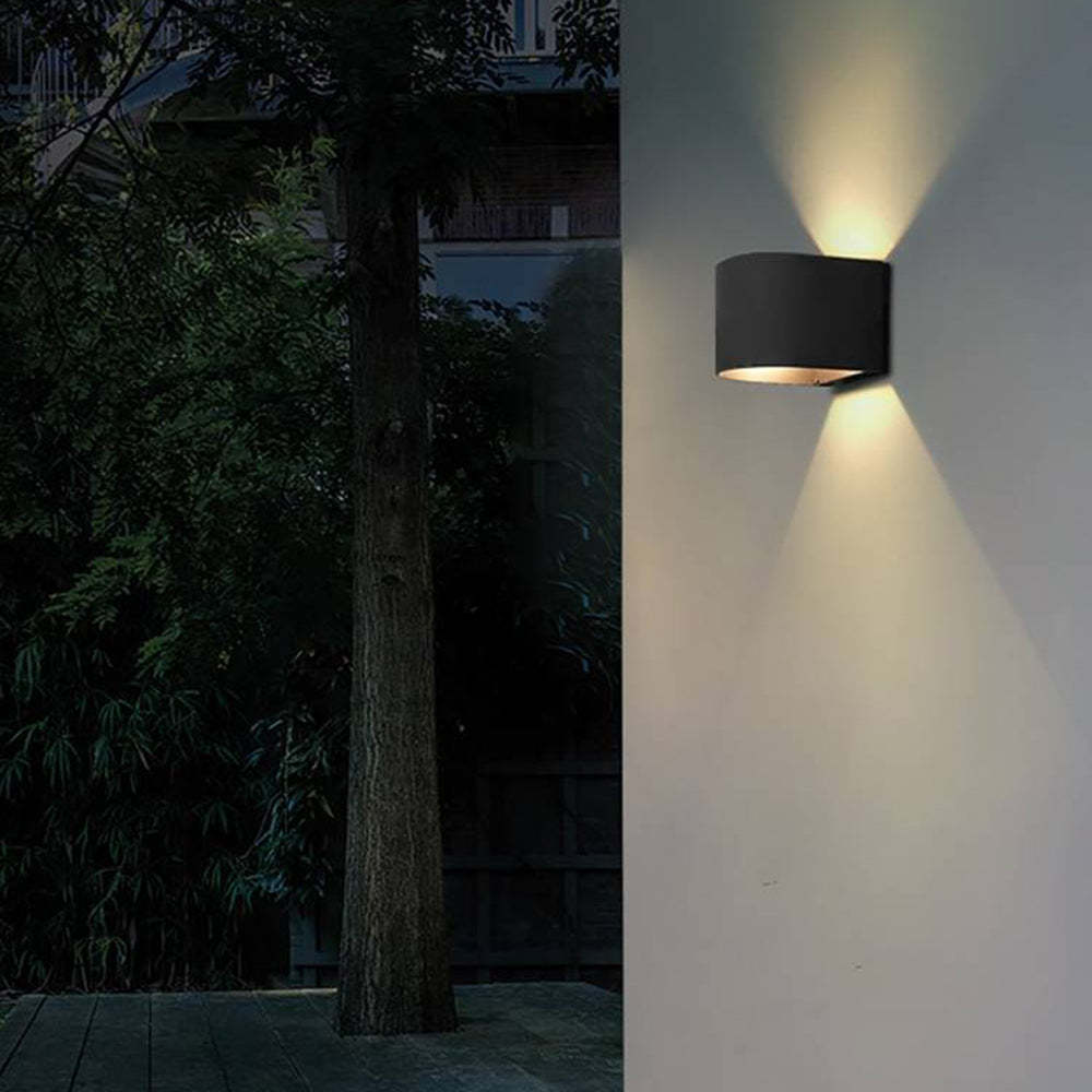 Black outdoor wall lamp lighting on the wall at night