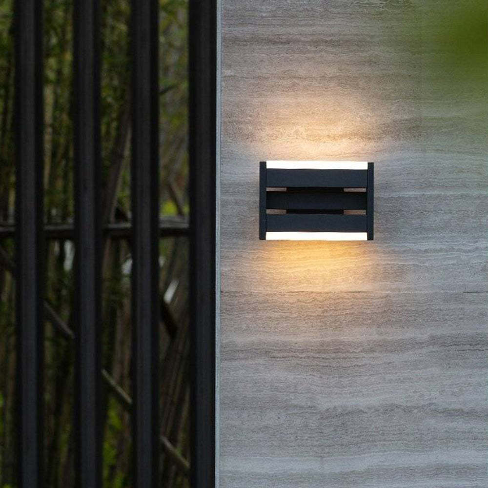 Orr Outdoor Wall Lamp illuminating a stone wall
