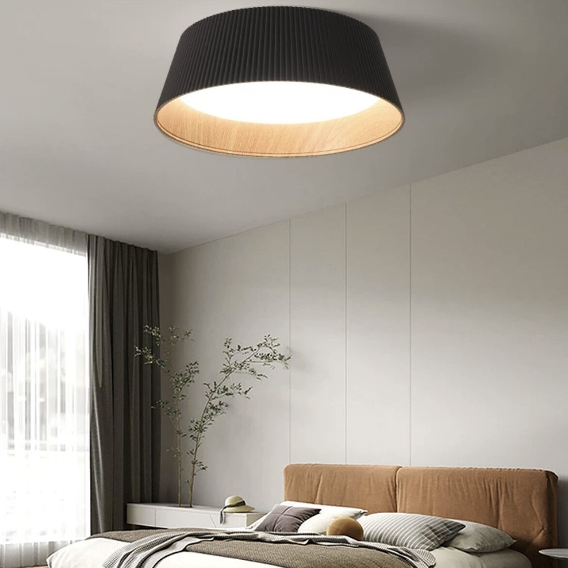 Black Alessio pendant light in a modern bedroom setting.