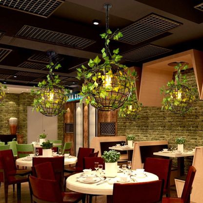 Rustic globe pendant light with vines in restaurant. Las Sola lighting.