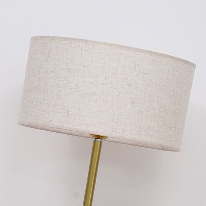 Eryn floor lamp with gold pole and fabric shade.