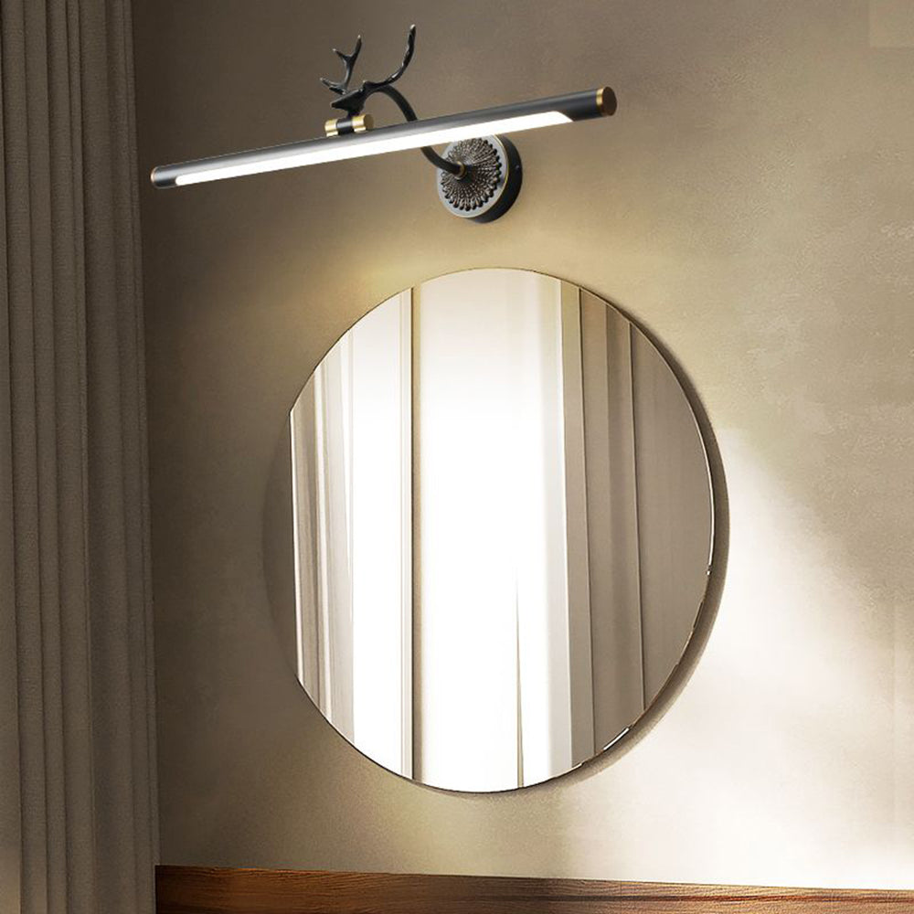 Brass staghorn vanity light. Modern wall lamp above mirror.