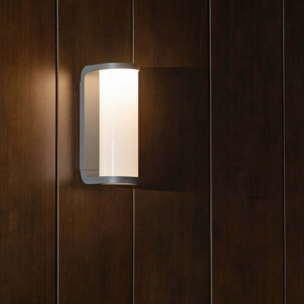 Las Sola Orr modern metal outdoor wall lamp on wood panel.