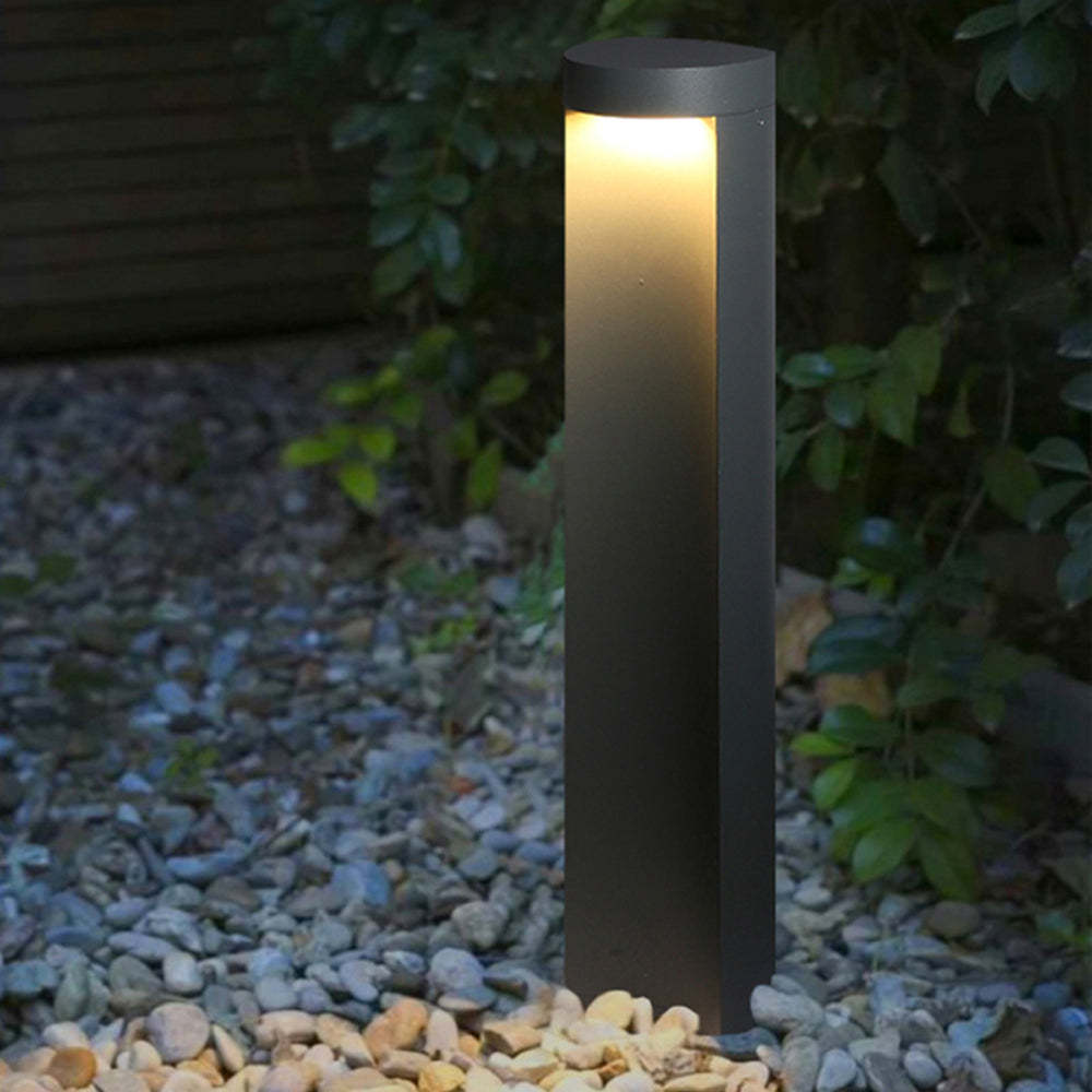 Pena Modern Outdoor Path Light illuminating a garden
