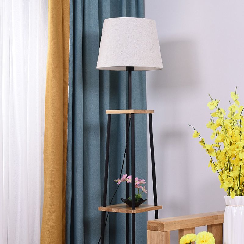 Eryn floor lamp: fabric shade, shelves & metal frame.