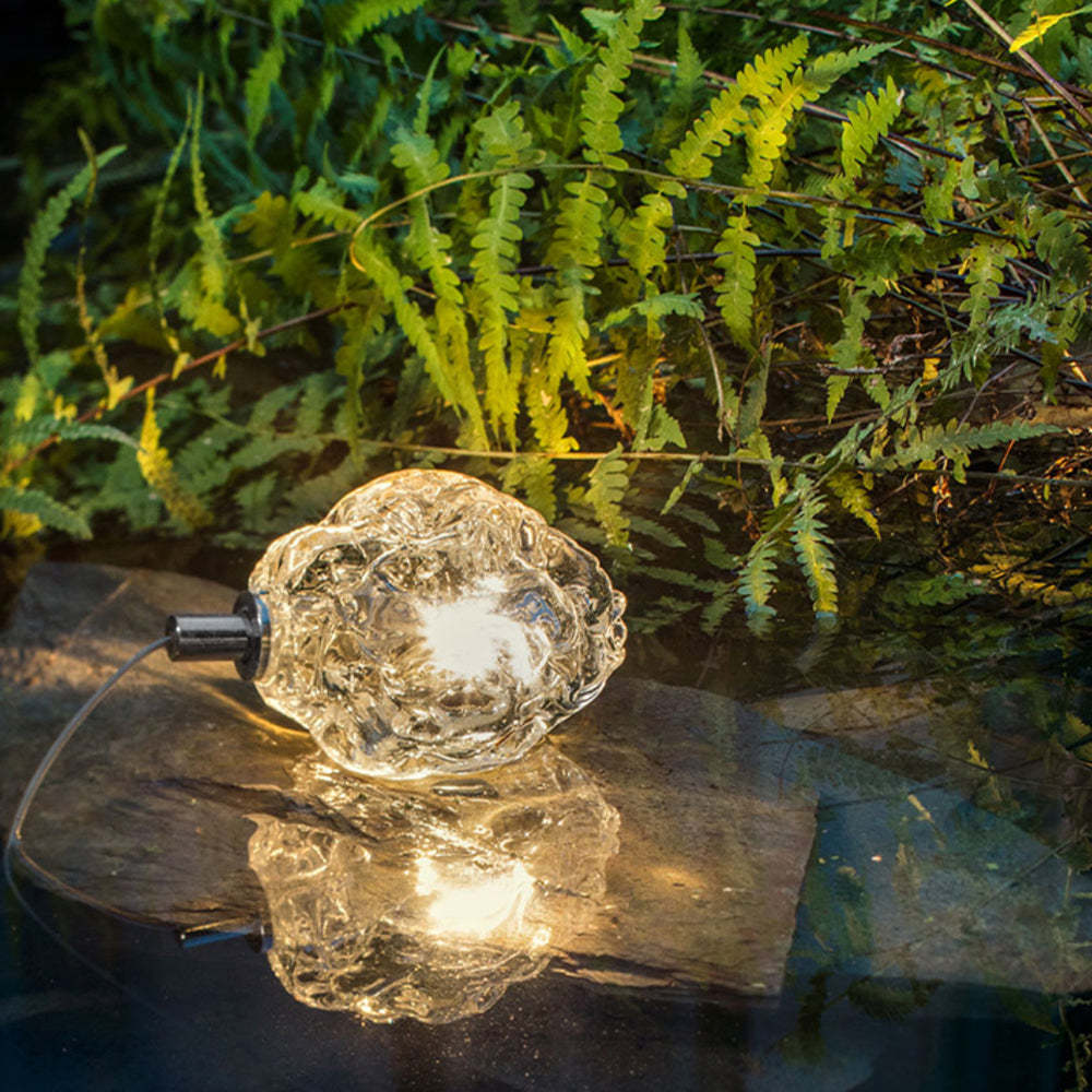 Bella Flower ground light reflecting in garden pond