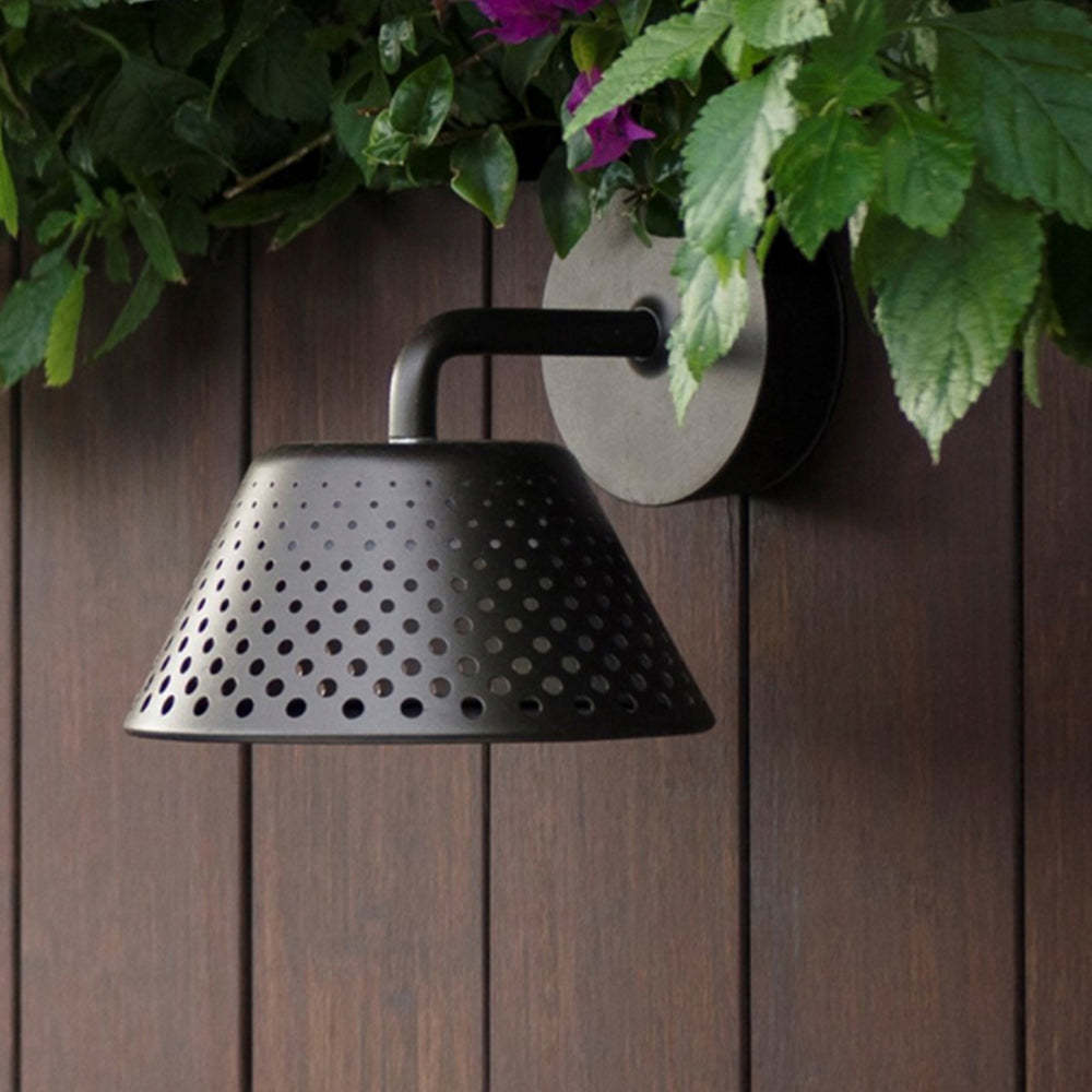 Carins metal wall lamp with perforated shade on wooden wall
