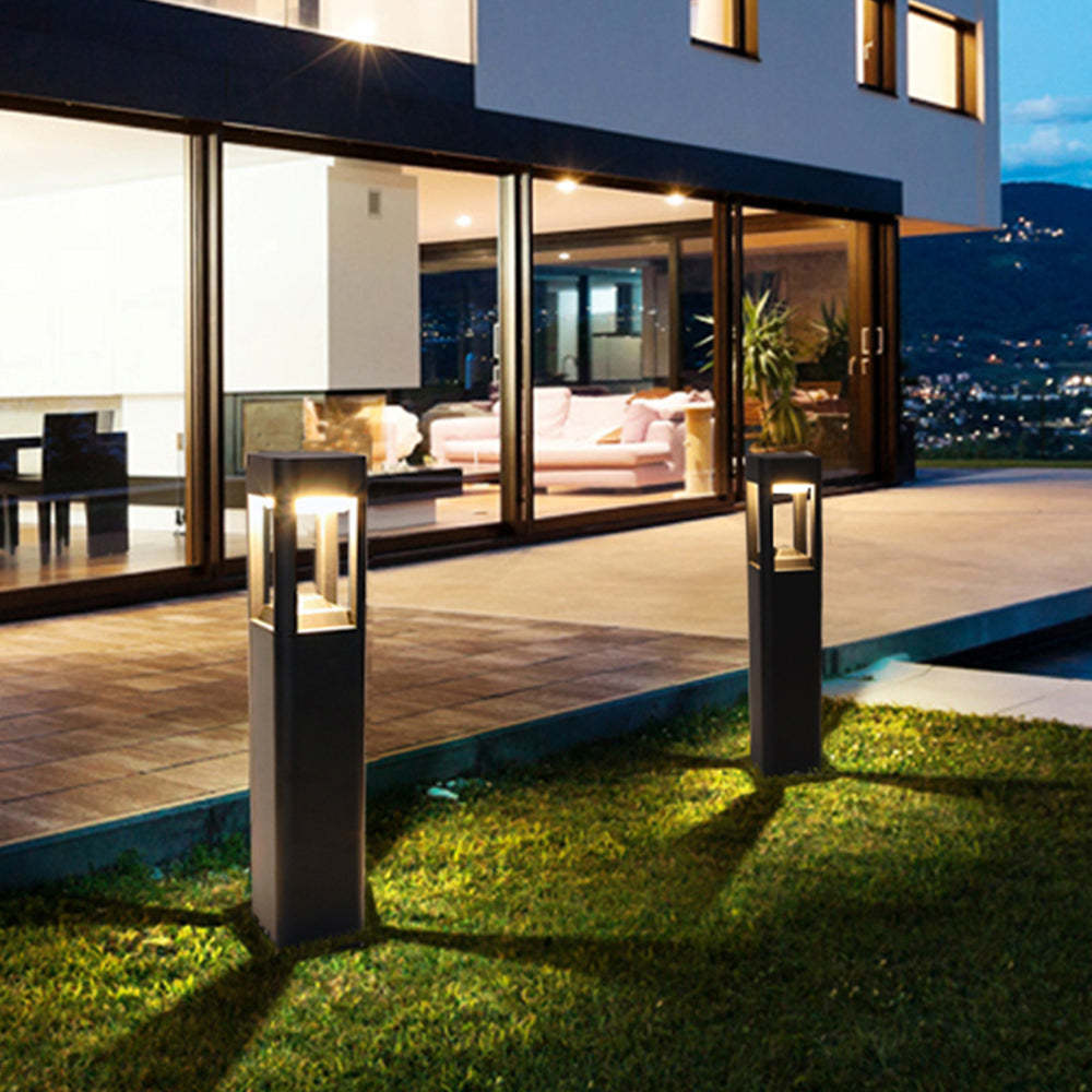 Modern outdoor path lights illuminating a garden at night