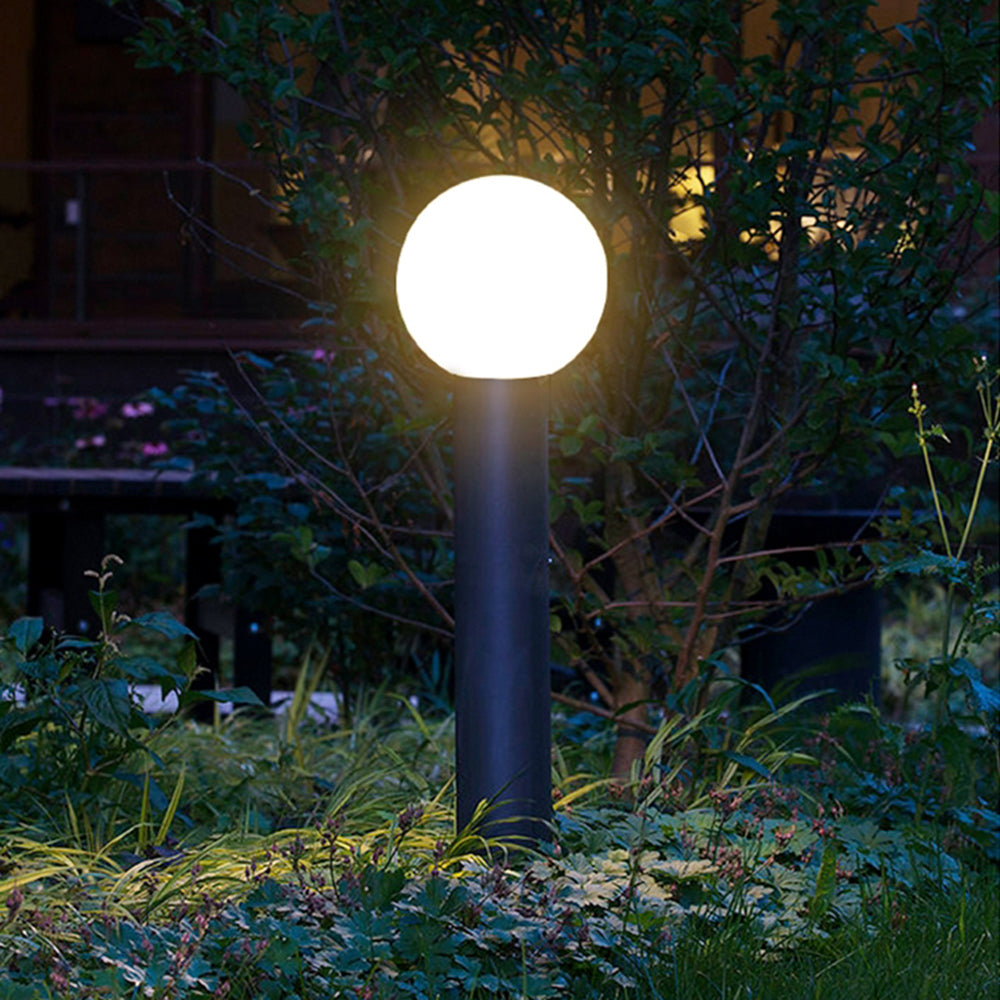 Pena Modern Outdoor Bollard Light illuminating garden