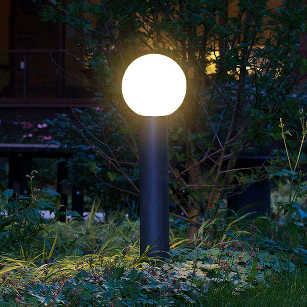 Pena Modern Outdoor Bollard Light illuminating garden