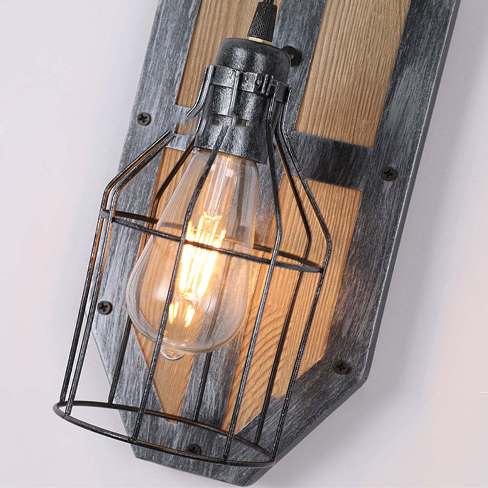 Metal birdcage wall lamp on wood, vintage style