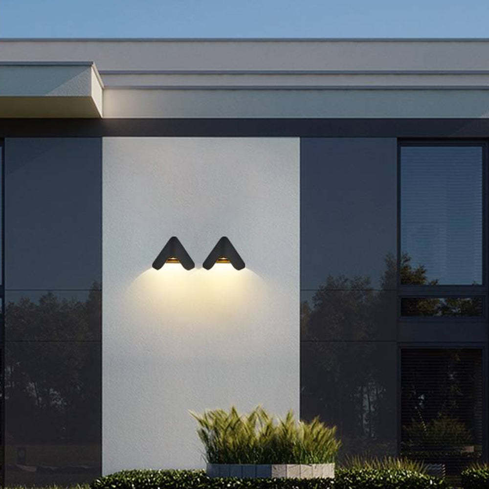 Outdoor triangle wall lamps illuminating a modern building exterior
