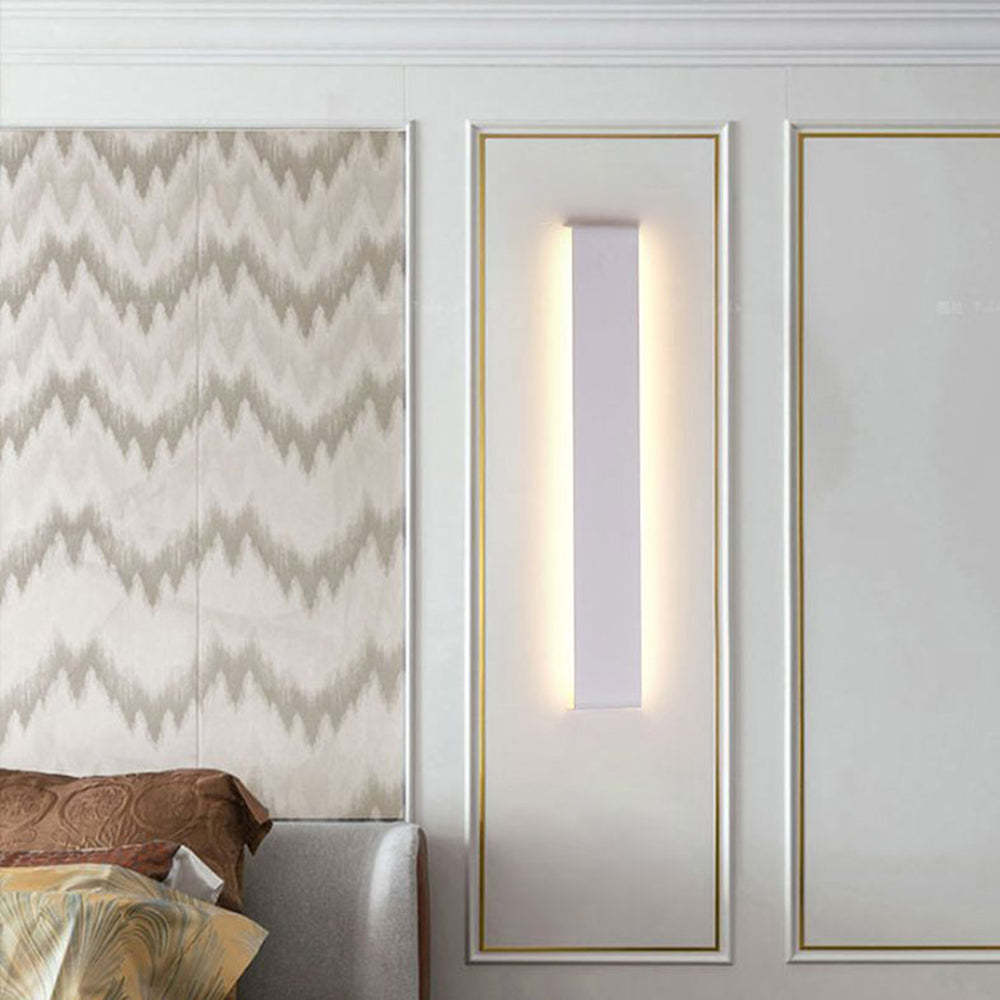 Edge Minimalist Rectangular Wall Lamp illuminating a bedroom wall