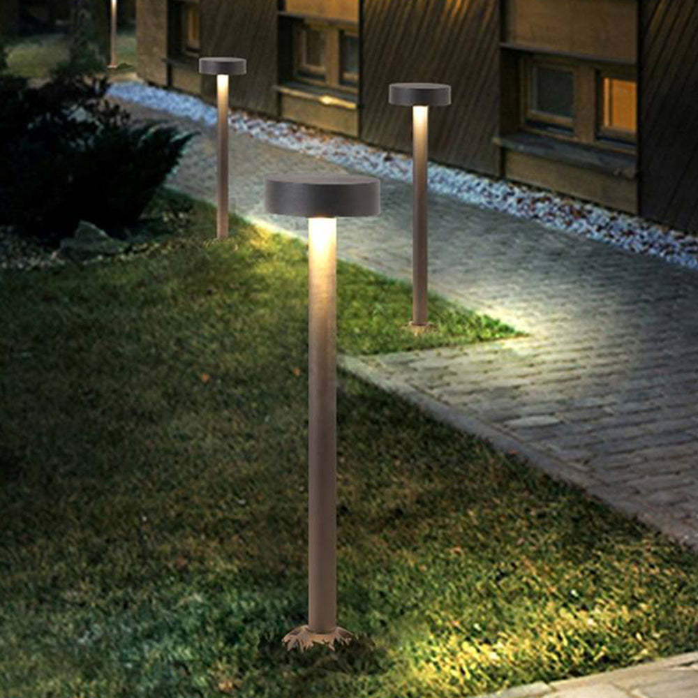 Pena Modern Outdoor Path Lights illuminating a garden path