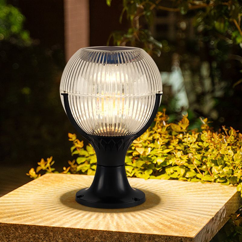 Hailie outdoor pillar light illuminating a garden at night