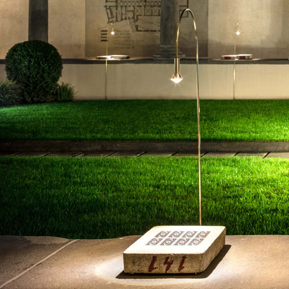 Las Sola Bella outdoor ground light in garden setting.
