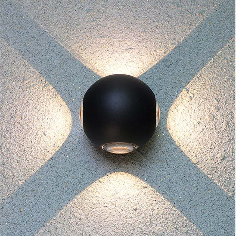 Modern black Orr outdoor wall lamp, cruciform ray light pattern