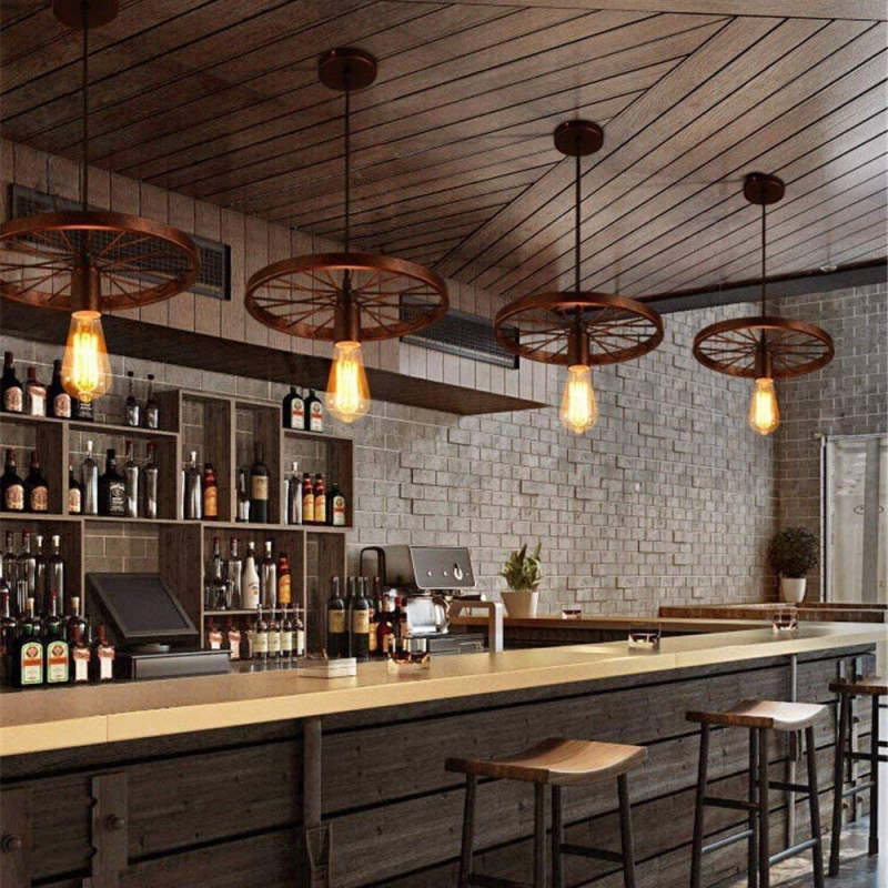 Rustic wagon wheel pendant lights over bar