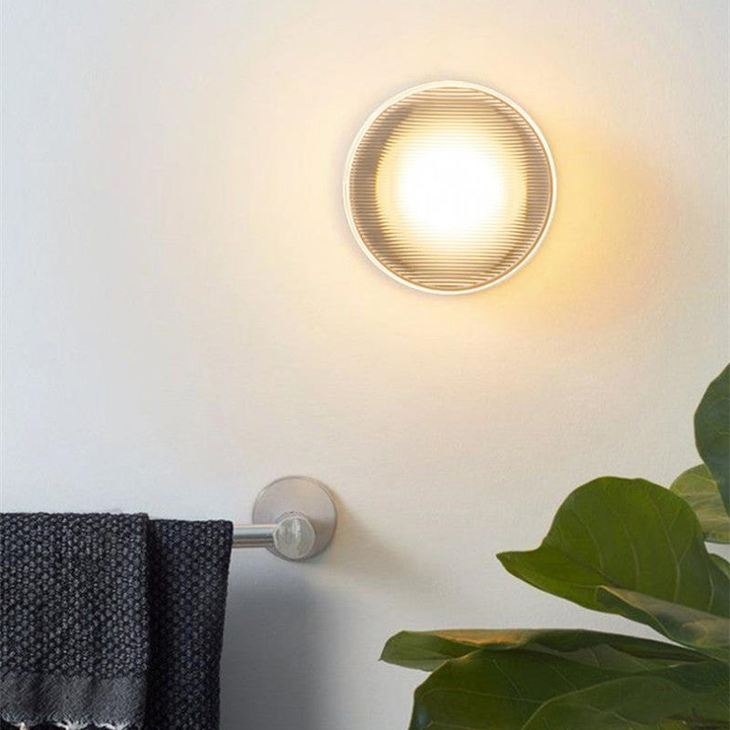 Modern round wall lamp illuminating bathroom space