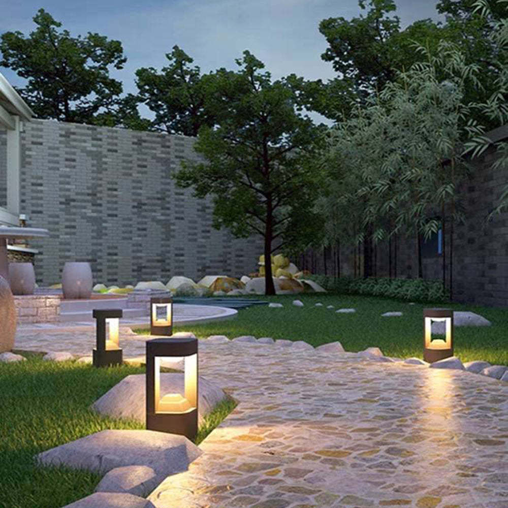Outdoor Pena path lights illuminate a garden path at night
