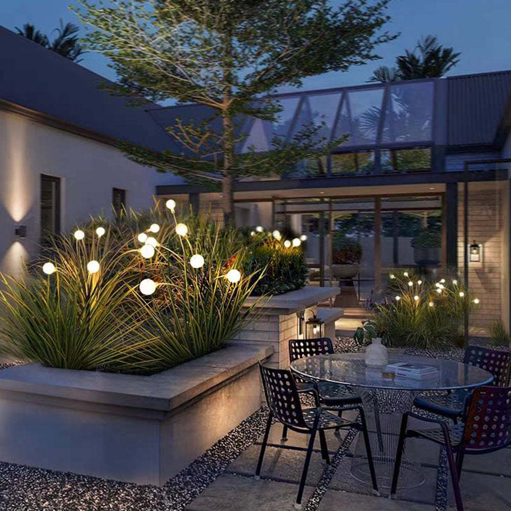 Orr Modern Outdoor Post Lights illuminating an outdoor patio at night