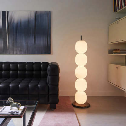Valentina Modern Lantern Glass Floor Lamp illuminating a living room