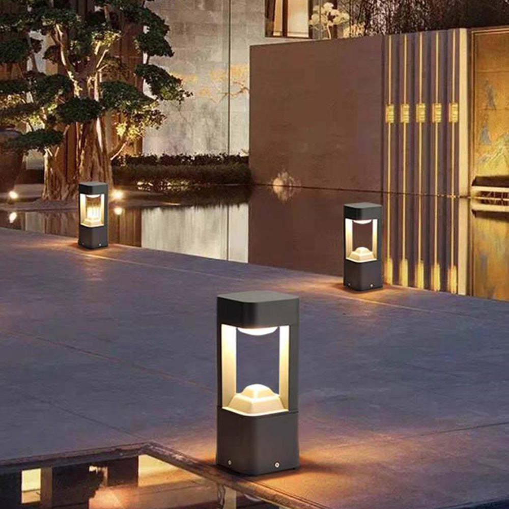 Pena Outdoor Path Lights illuminating a modern courtyard at night
