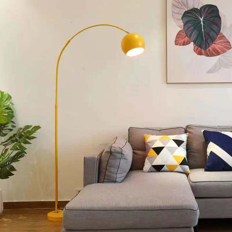 Yellow Morandi arc floor lamp near sofa. Las Sola lighting. Morandi Modern Fishing 1 Light Arc Floor Lamp Metal