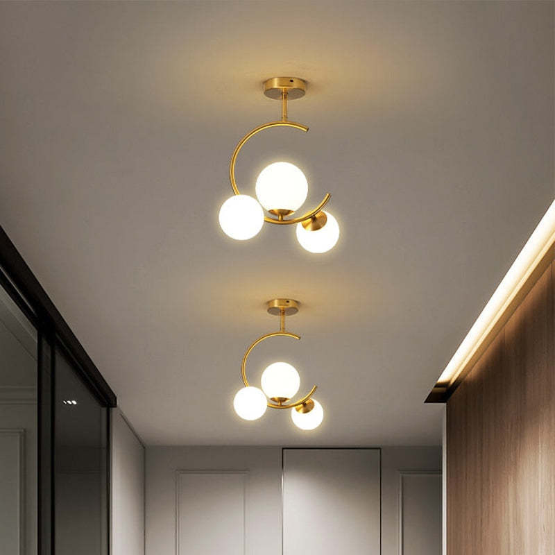 Valentina pendant lights in hallway, gold finish, glass globes
