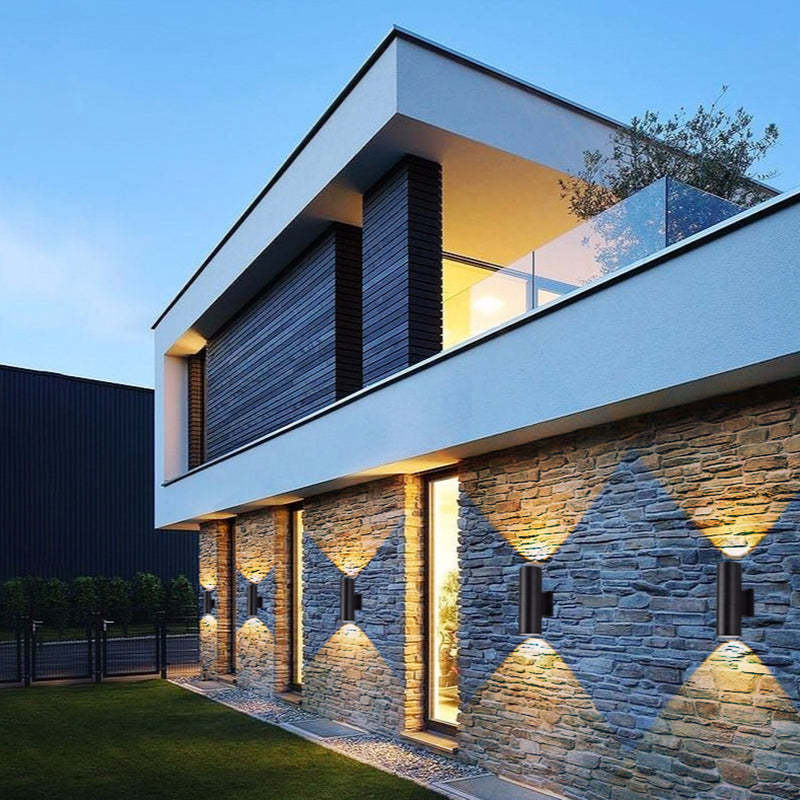Modern home exterior lit by Orr double-headed outdoor lamps