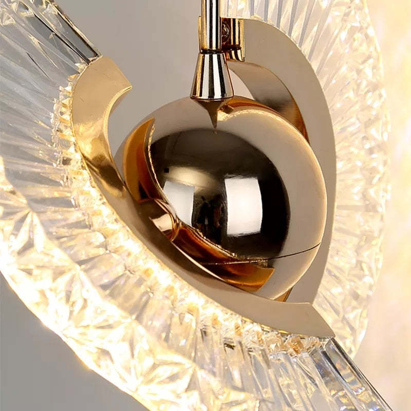 Gold pendant light detail with crystal accents, luxury lighting.