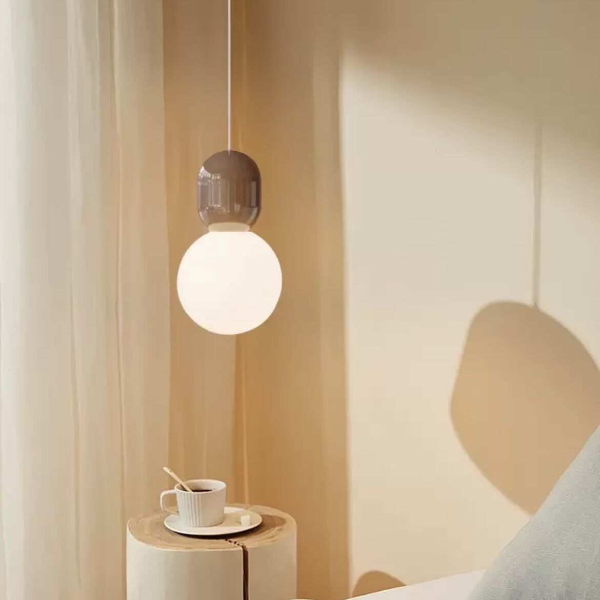 Hailie Modern Pendant Light in bedroom setting with coffee