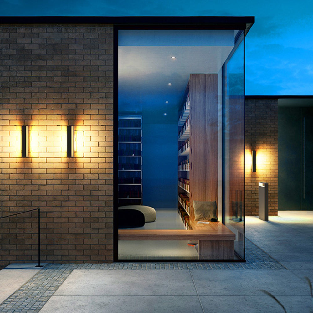 Orr Modern Outdoor Wall Lamp illuminating brick facade at dusk
