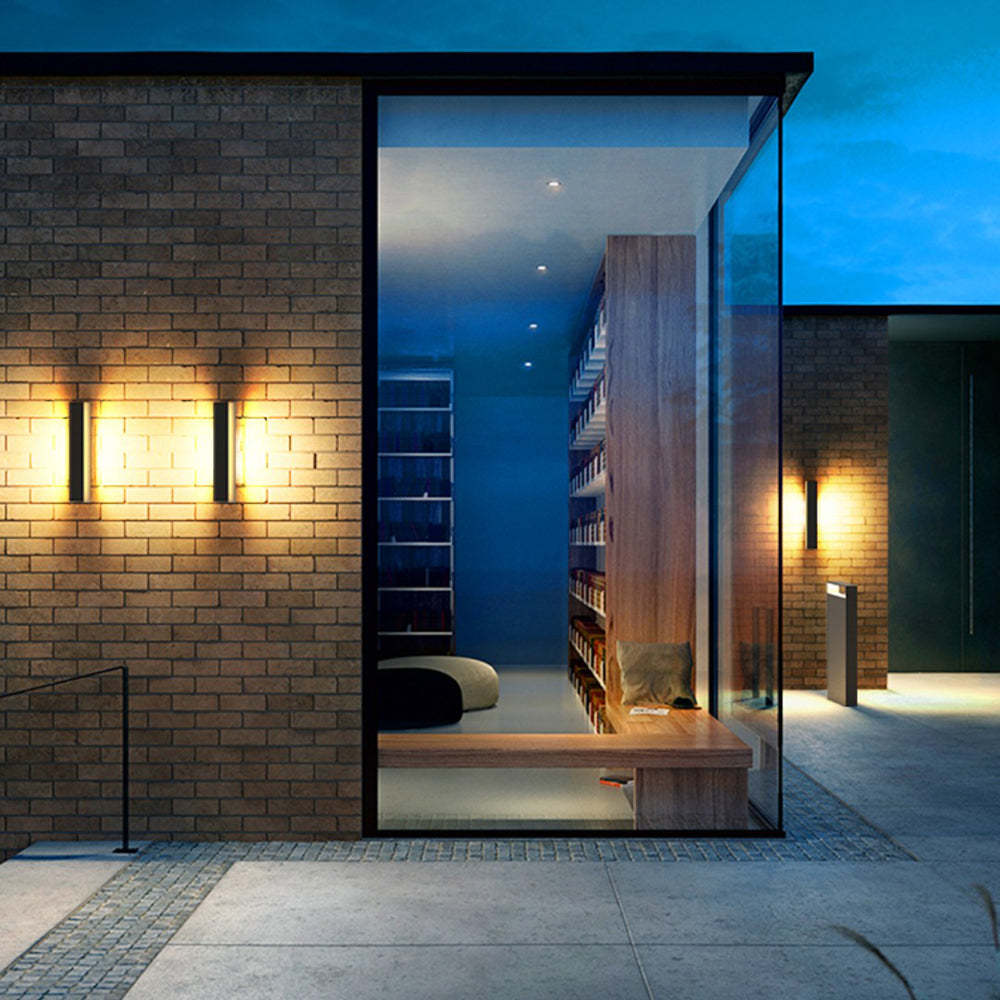 Orr Modern Outdoor Wall Lamp illuminating brick facade at dusk