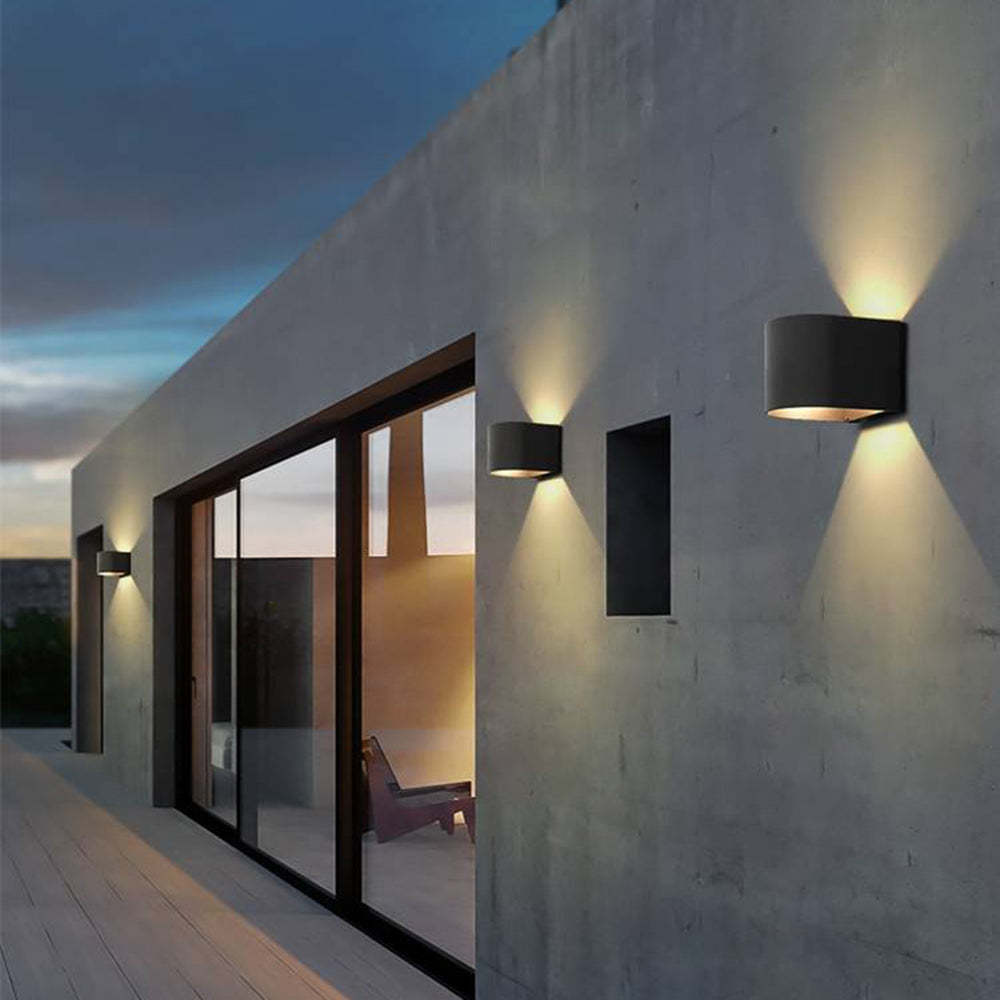 Orr Modern Cylinder Outdoor Wall Lamp illuminating house exterior