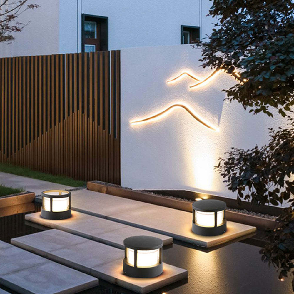 Pena outdoor bollard lights illuminating modern garden