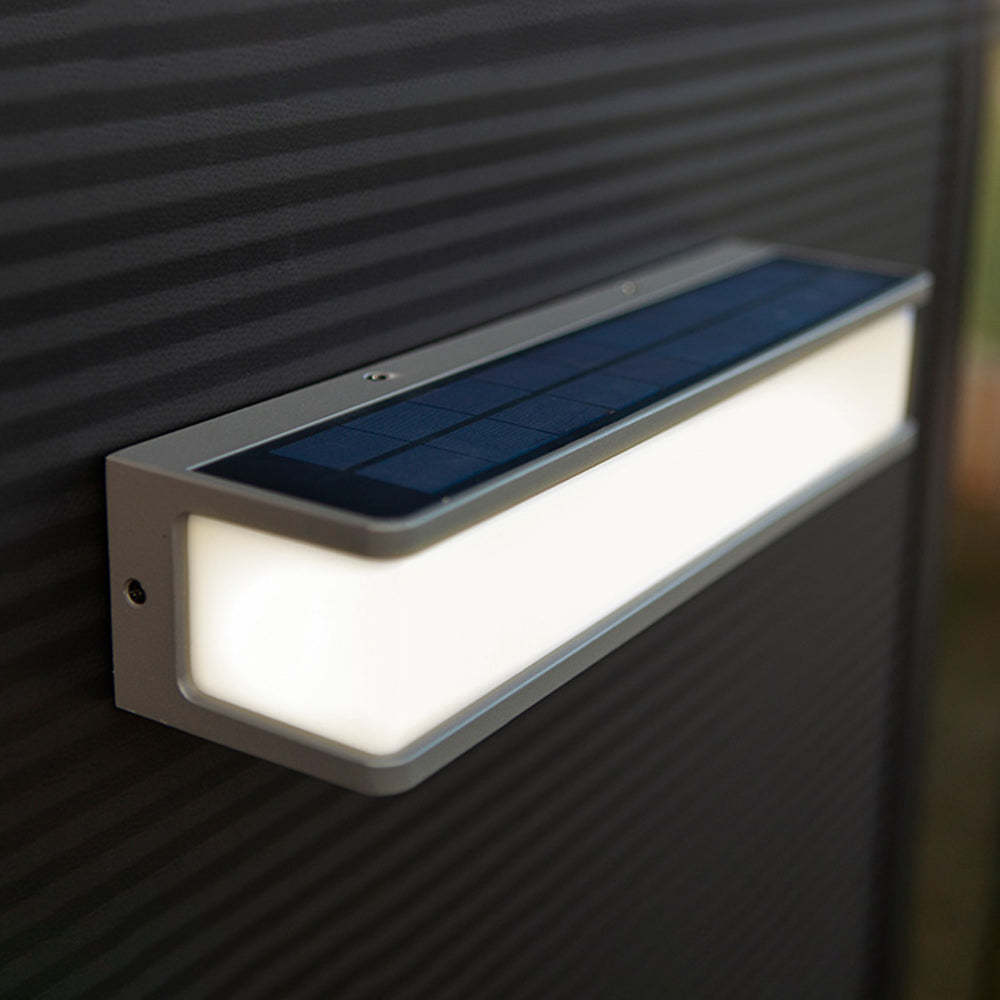 Orr solar wall light on dark siding. Modern outdoor lamp.