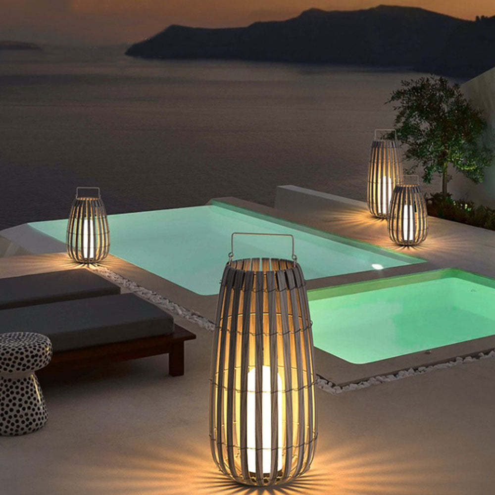Orr outdoor metal cage floor lamps by pool at dusk.