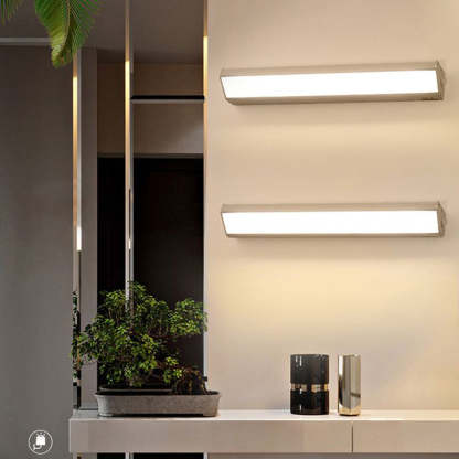 Modern Orr sconce lights above console table.