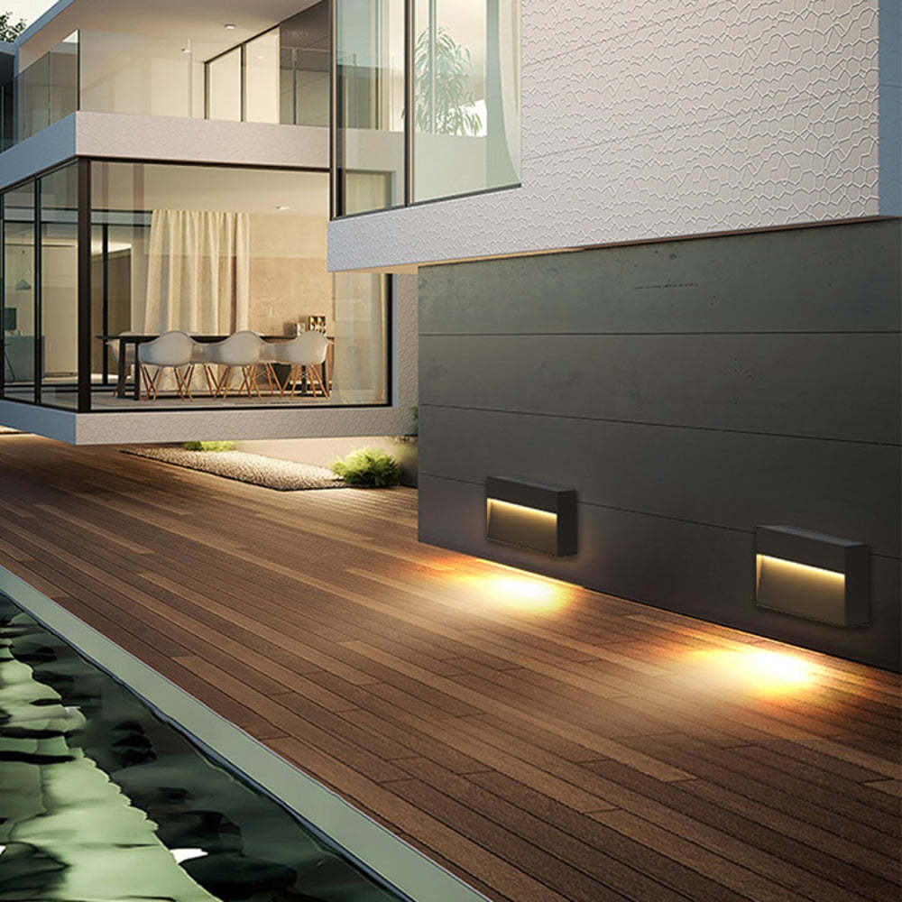 Outdoor deck lighting illuminating modern home exterior